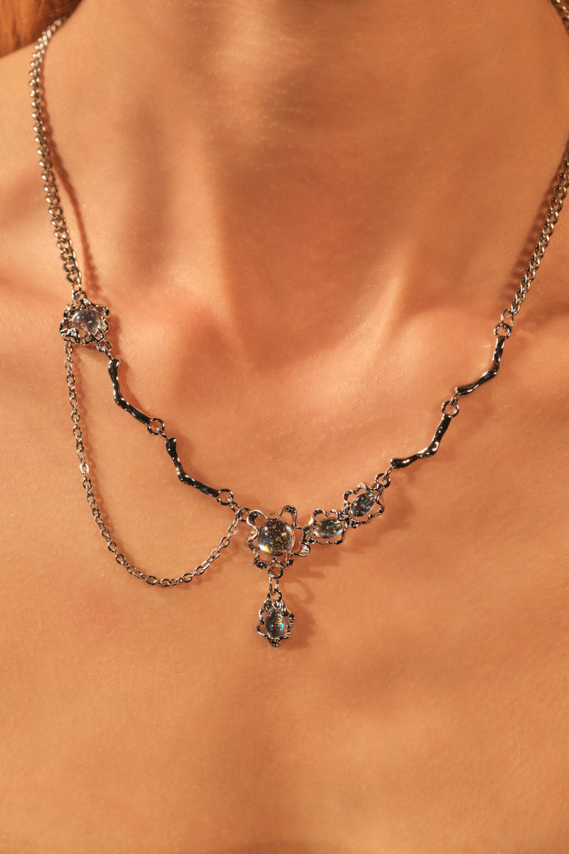 Palladium white-gold-plated dangle necklace with a glowing red zirconia gemstone
