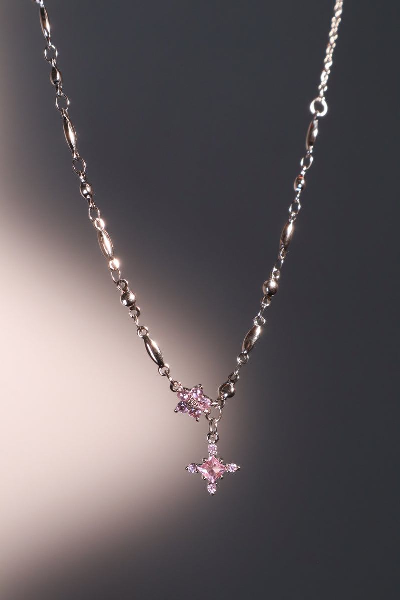 Palladium white-gold-plated cross necklace set with pink zirconia gemstones