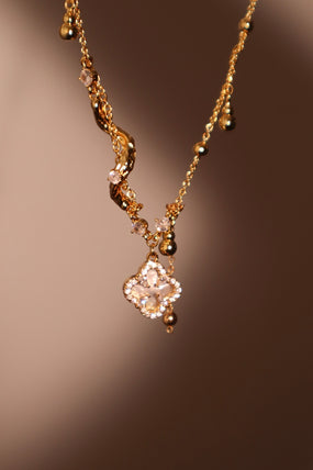 Gold-plated spiral necklace with lucky leaf motif, natural shell pearls and zirconia diamonds