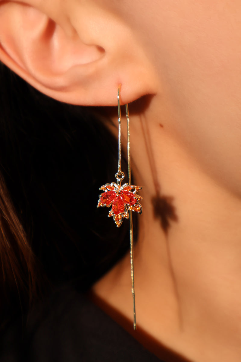 Gold-plated maple leaf dangle earrings with red zirconia stones on sterling silver posts