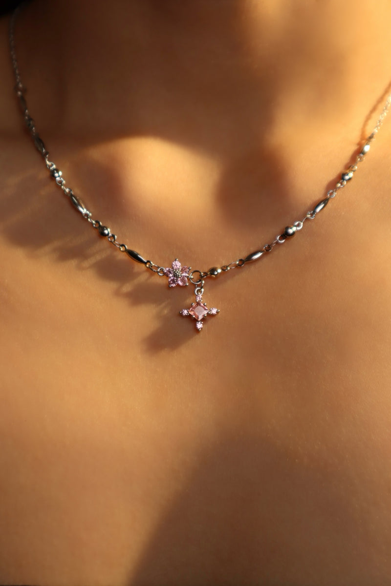 Palladium white-gold-plated cross necklace set with pink zirconia gemstones