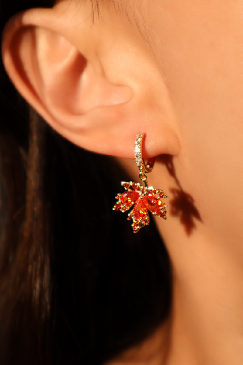 Gold-plated maple leaf earrings set with red zirconia stones on sterling silver posts