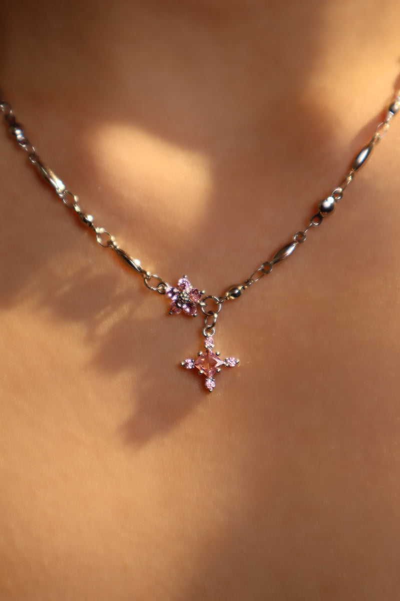 Palladium white-gold-plated cross necklace set with pink zirconia gemstones