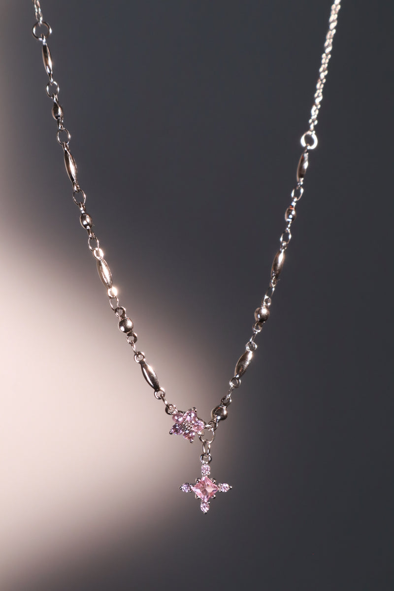 Palladium white-gold-plated cross necklace set with pink zirconia gemstones