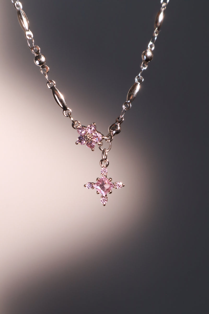 Palladium white-gold-plated cross necklace set with pink zirconia gemstones