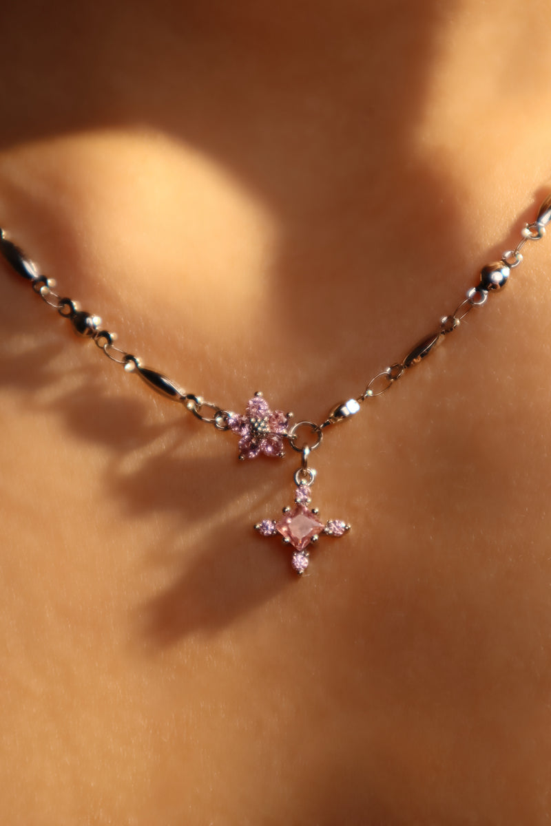 Palladium white-gold-plated cross necklace set with pink zirconia gemstones