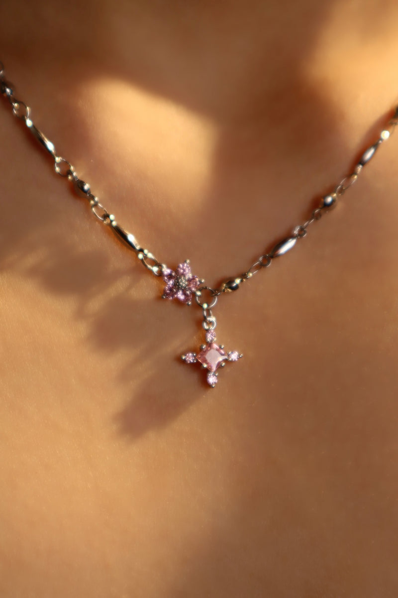 Palladium white-gold-plated cross necklace set with pink zirconia gemstones
