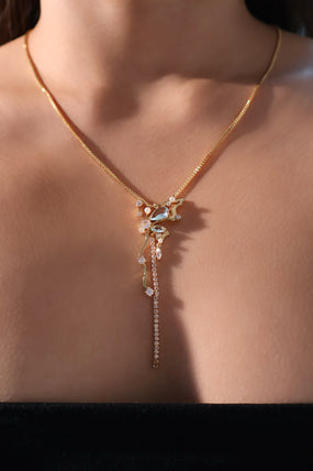 Gold-plated butterfly pendant necklace set with blue cubic zirconia gemstones on a fine chain