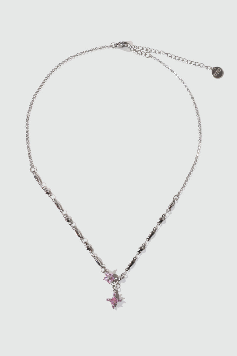 Palladium white-gold-plated cross necklace set with pink zirconia gemstones