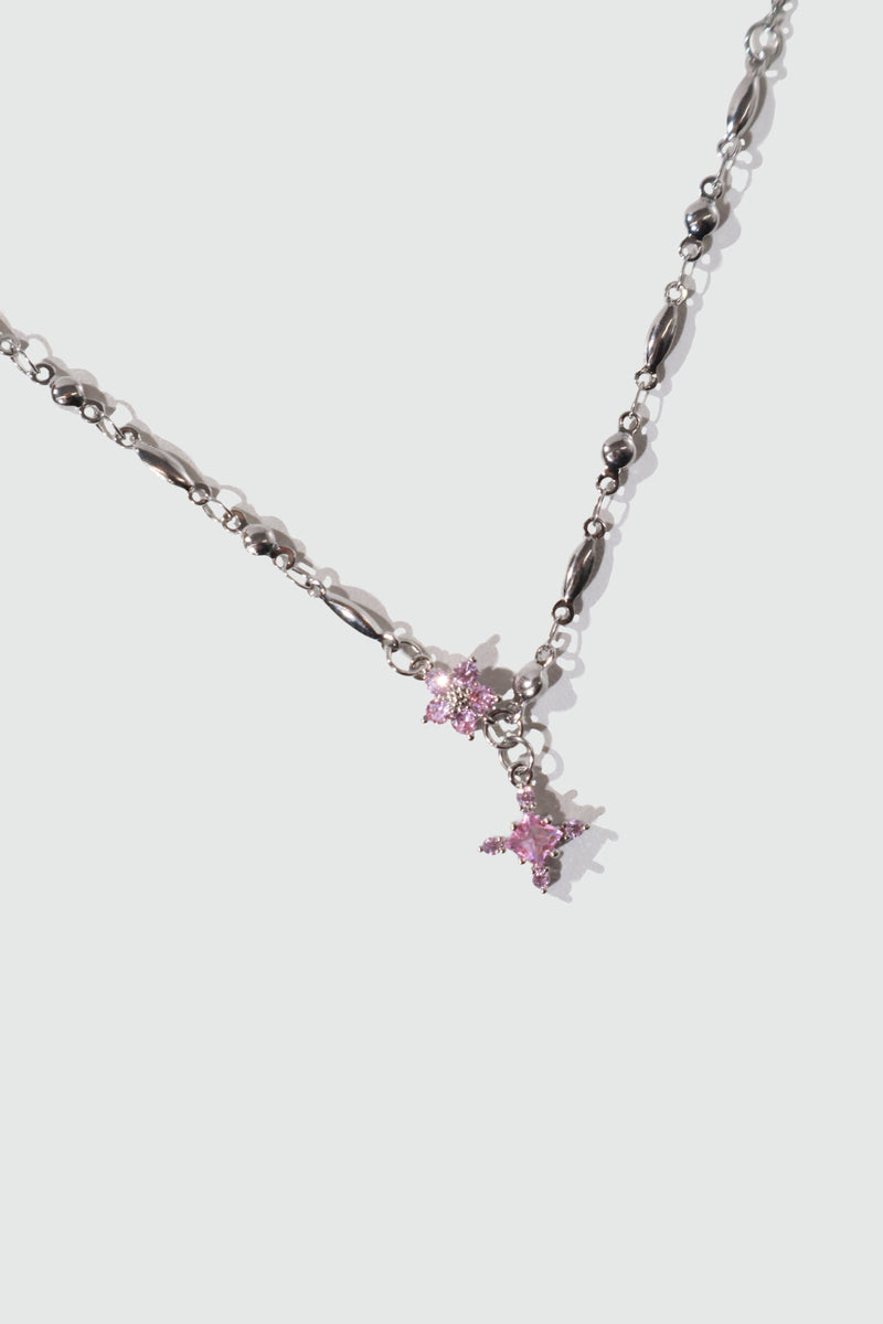 Palladium white-gold-plated cross necklace set with pink zirconia gemstones