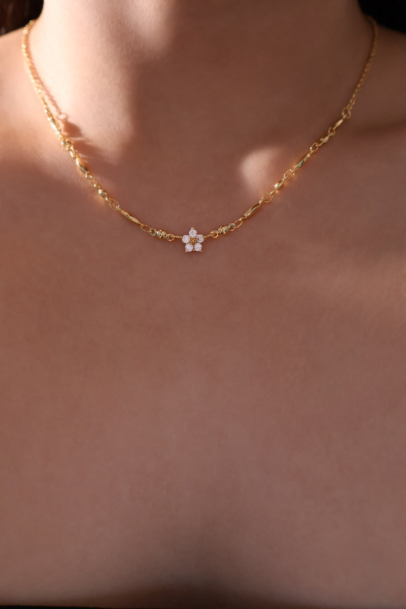 Three gold-plated necklaces with starlight bloom, cross, and shell moon pendants for layering