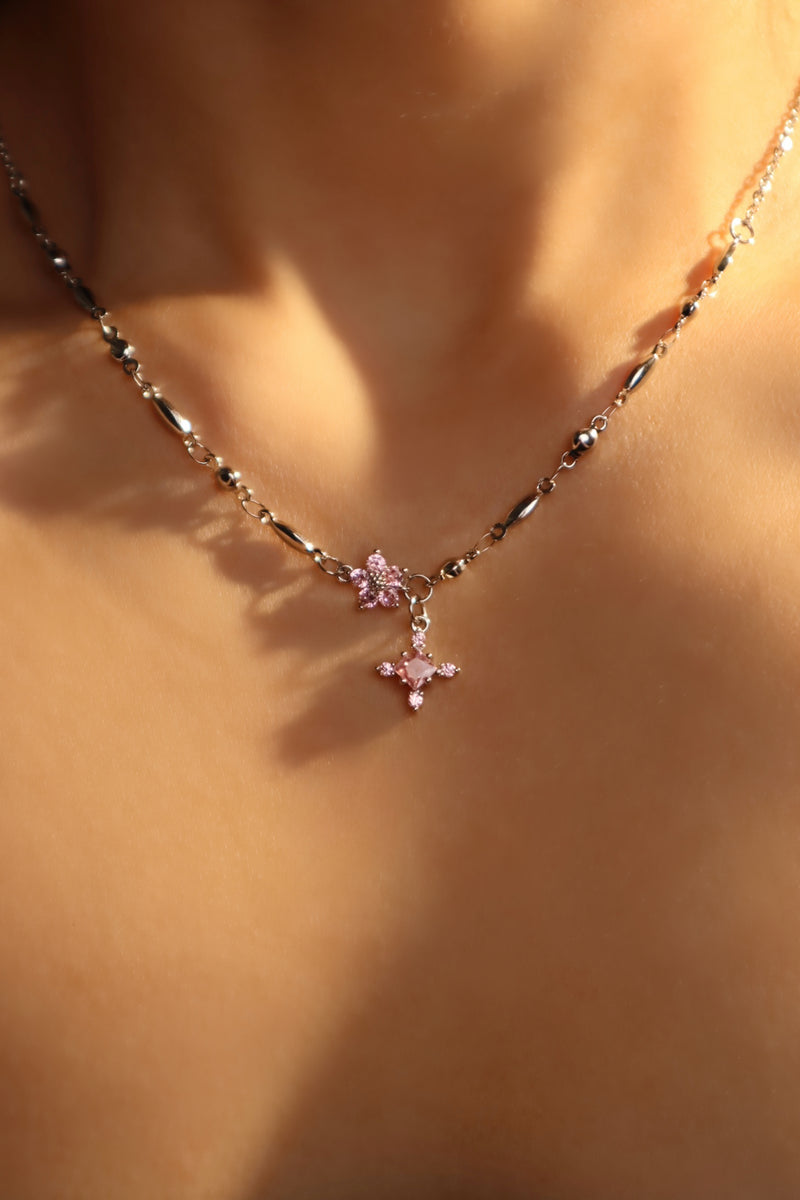 Palladium white-gold-plated cross necklace set with pink zirconia gemstones