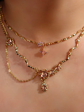 Gold-plated dangle necklace with a glittering pink cubic zirconia gemstone on a fine chain