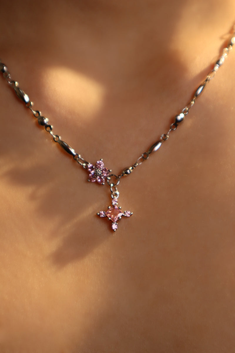 Palladium white-gold-plated cross necklace set with pink zirconia gemstones