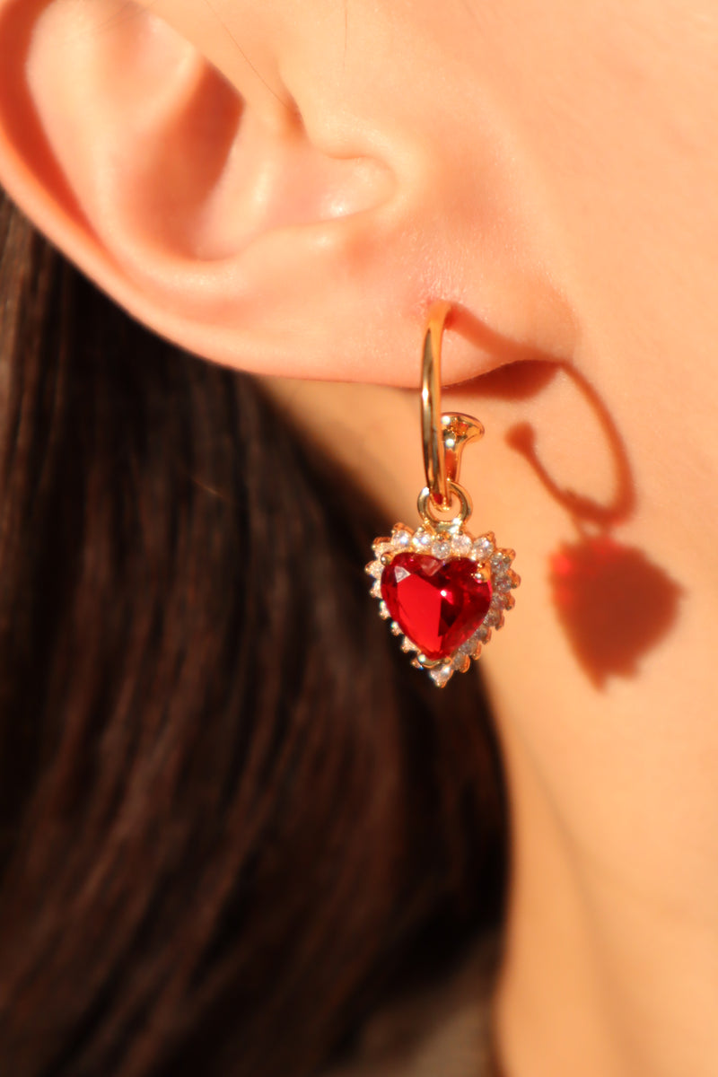 Gold-plated heart earrings with a red zirconia gemstone and sparkling zirconia diamonds