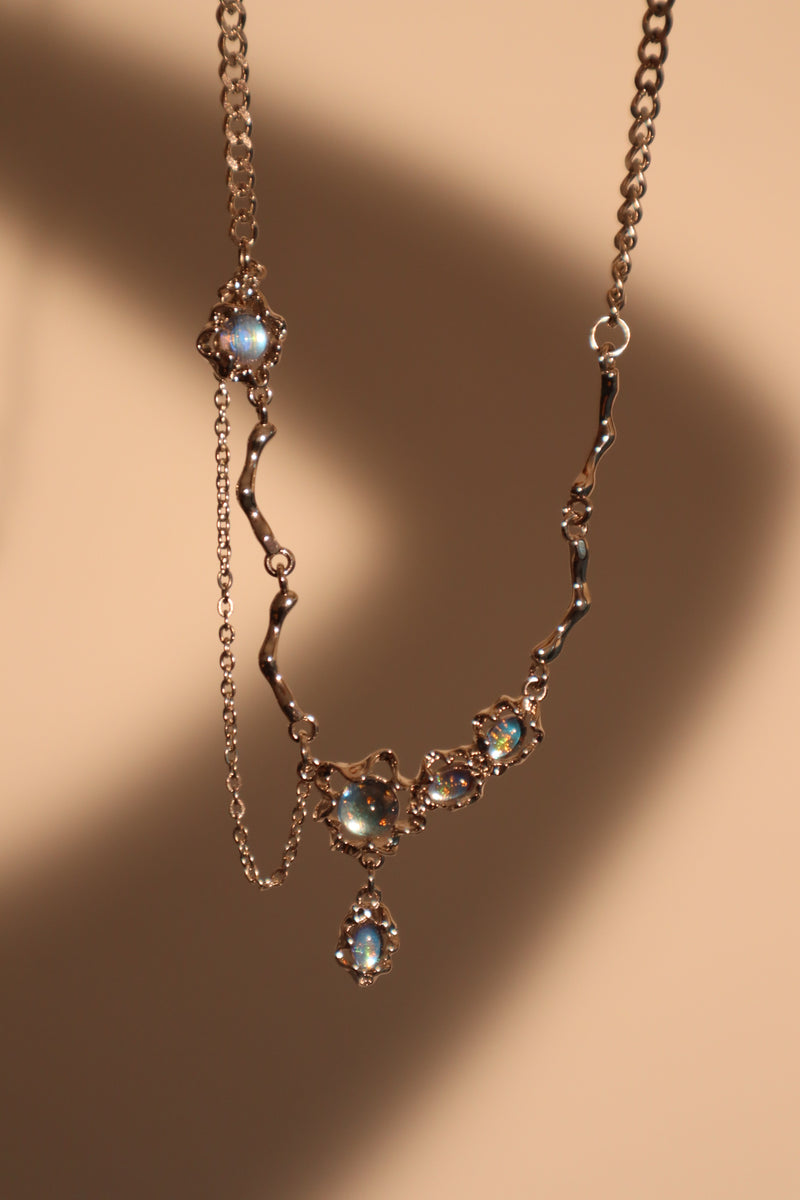 Palladium white-gold-plated dangle necklace with a glowing red zirconia gemstone
