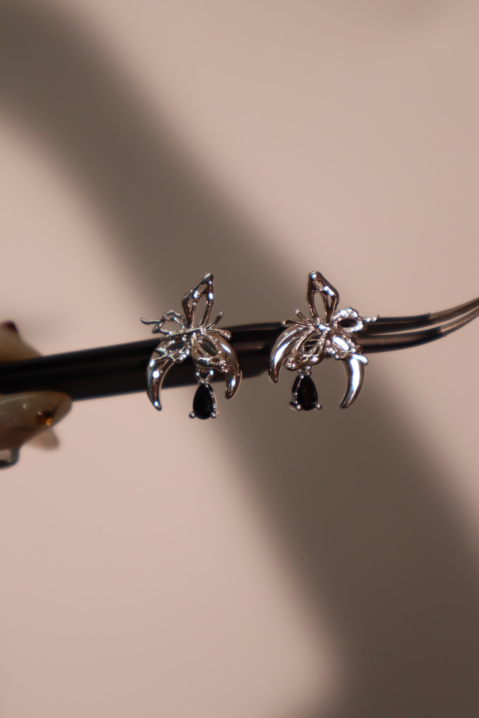 Platinum plated black gem butterfly moon earrings