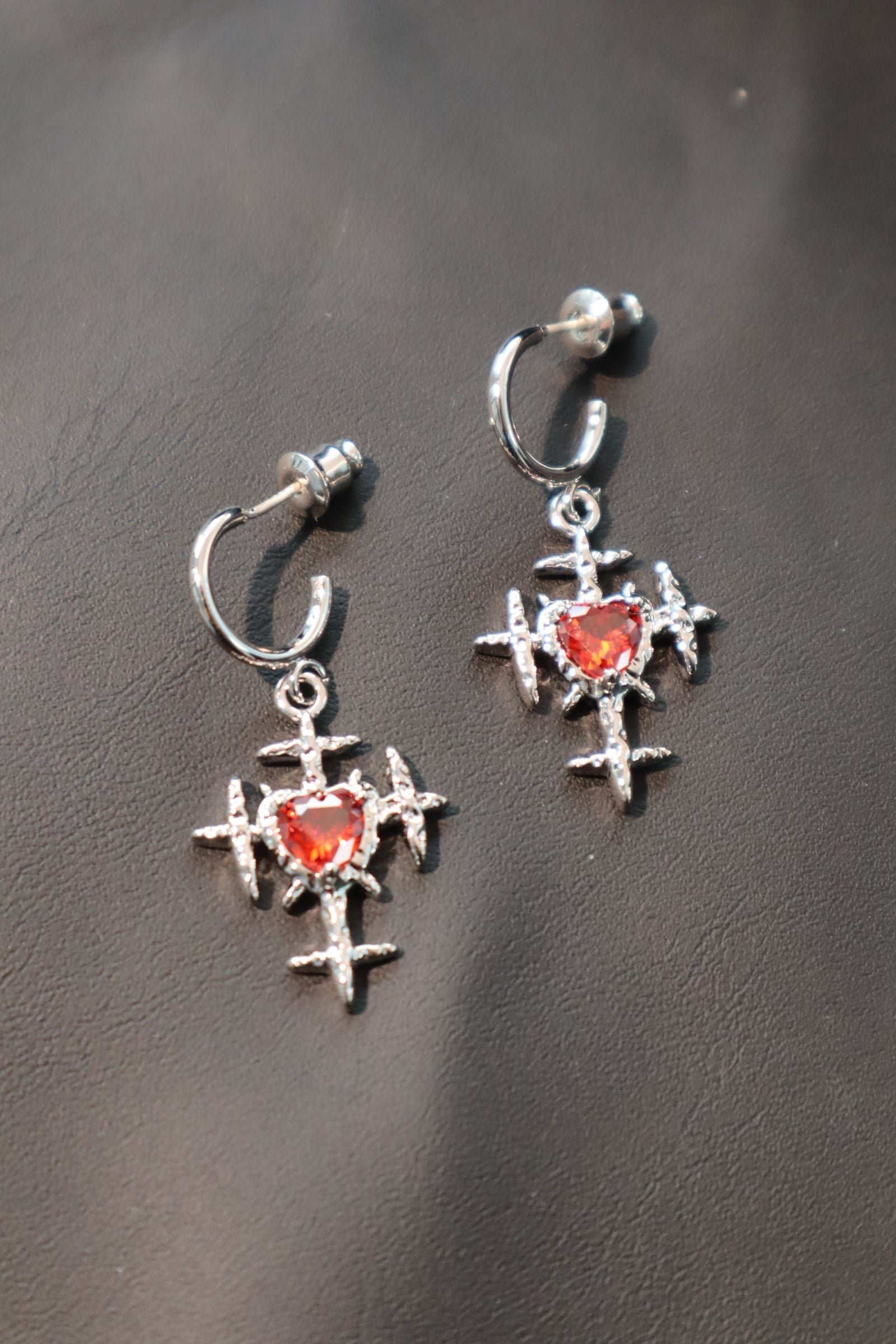 Platinum plated red gems cross earrings