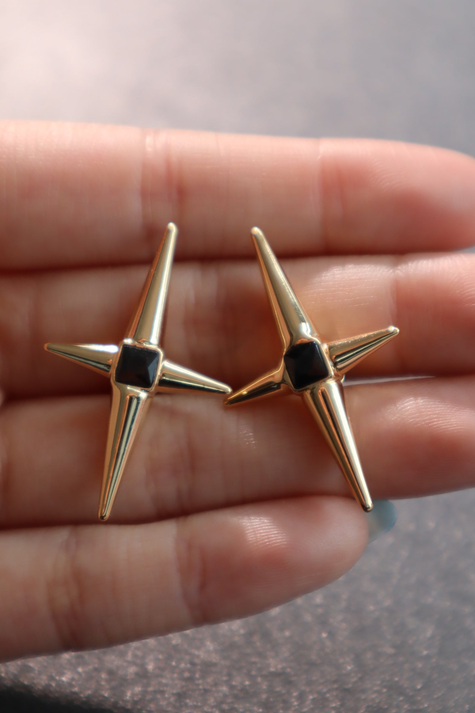 Gold black star earrings