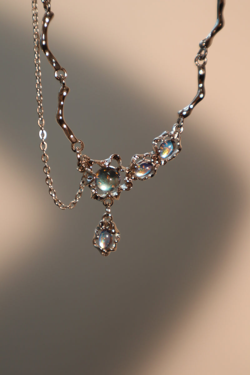 Palladium white-gold-plated dangle necklace with a glowing red zirconia gemstone