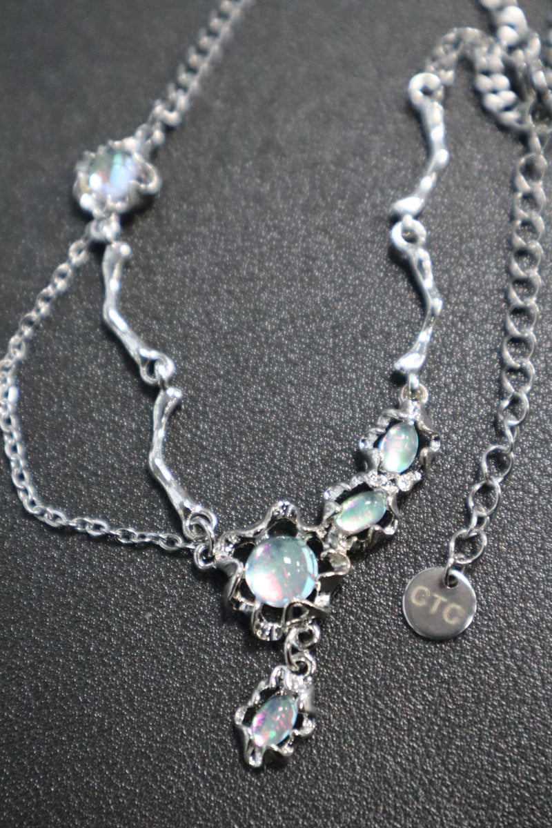 Palladium white-gold-plated dangle necklace with zirconia opal pendants on a stainless steel chain
