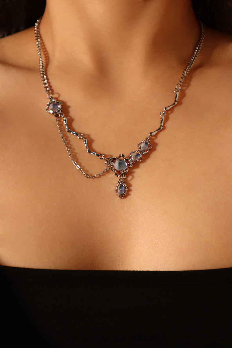 Palladium white-gold-plated dangle necklace with a glowing red zirconia gemstone