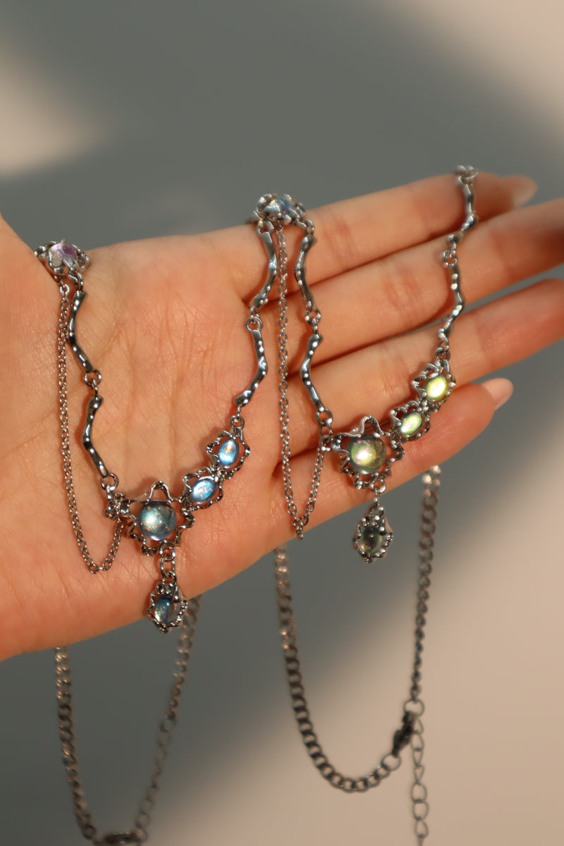 Palladium white-gold-plated dangle necklace with a glowing red zirconia gemstone