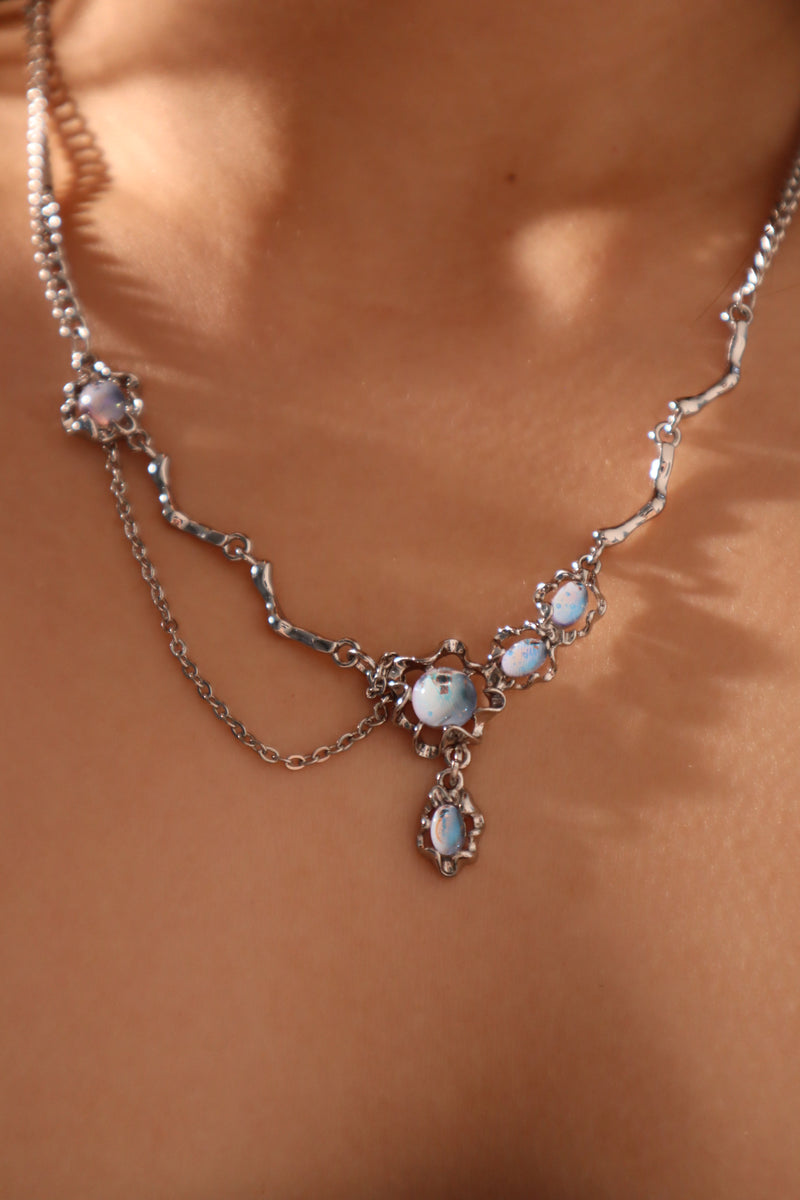 Palladium white-gold-plated dangle necklace with a glowing red zirconia gemstone