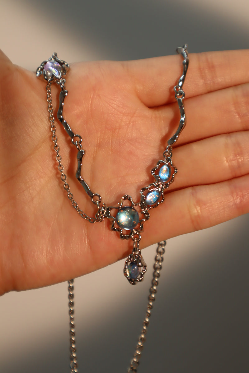 Palladium white-gold-plated dangle necklace with a glowing red zirconia gemstone