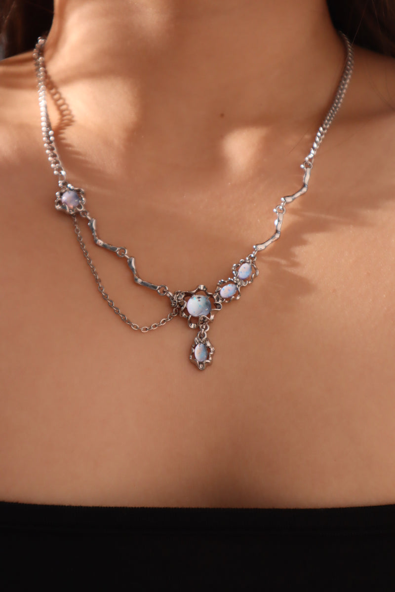 Palladium white-gold-plated dangle necklace with a glowing red zirconia gemstone