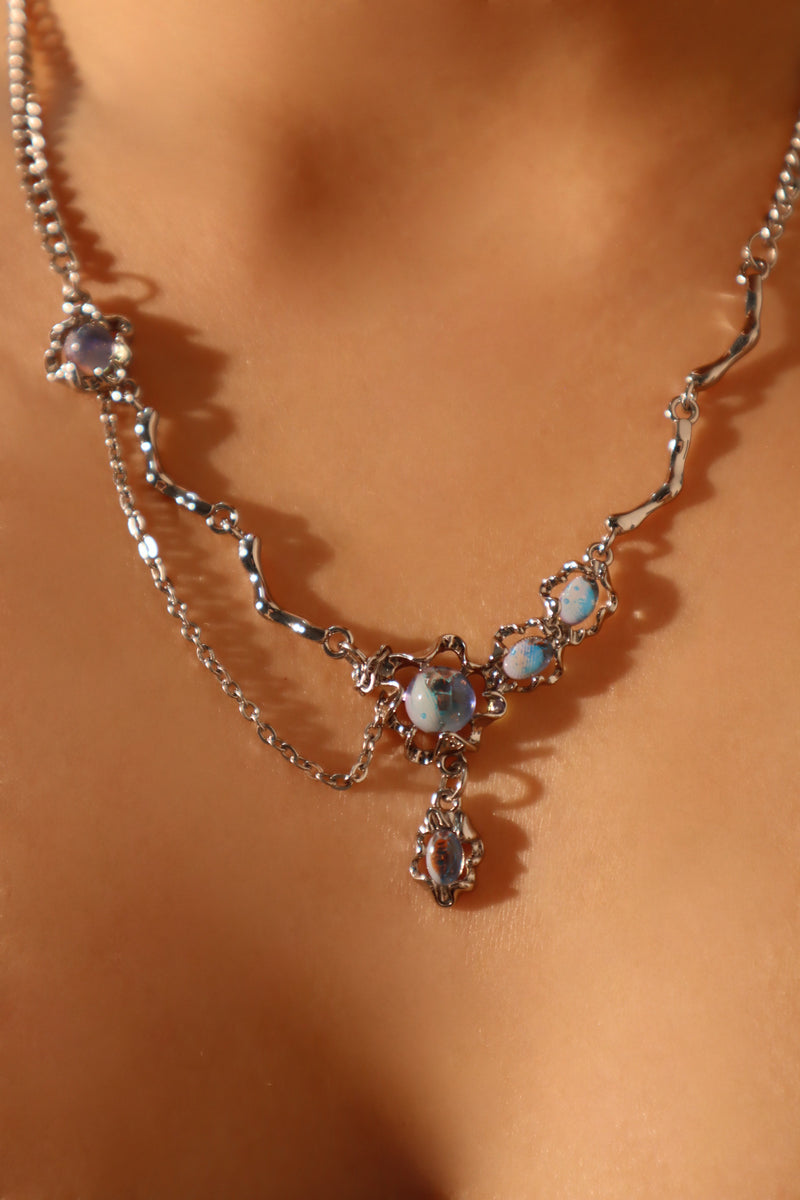 Palladium white-gold-plated dangle necklace with a glowing red zirconia gemstone
